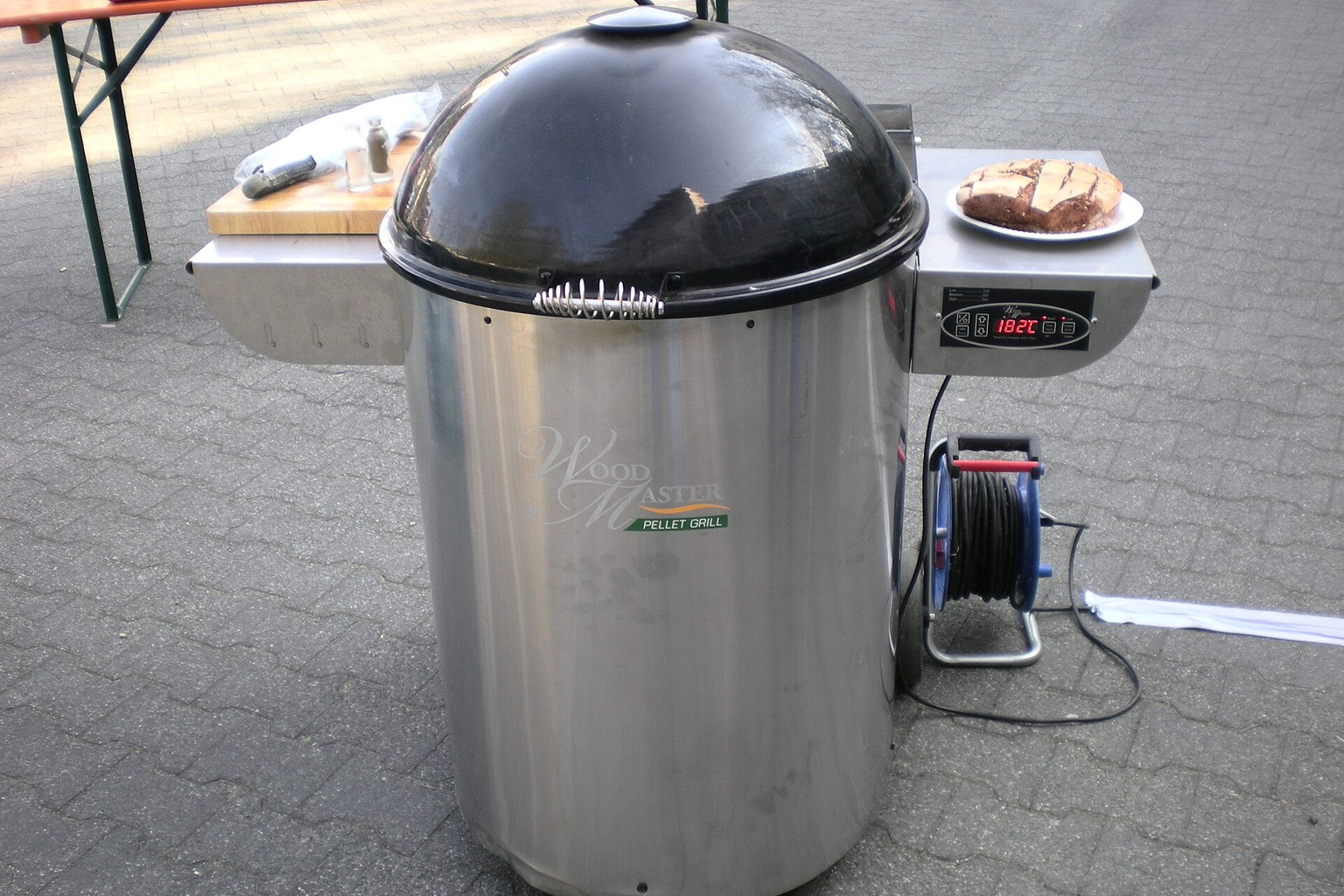 A kettle-style pellet grill with side hopper. Confirm exact dimensions and transport requirements before buying.